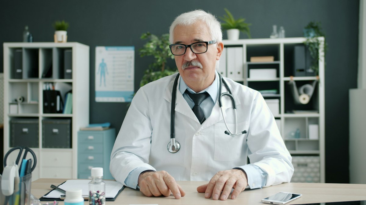 Doctor wearing a stethoscope at his desk